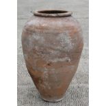 A large terracotta olive jar, 54cms (21.25ins) high.