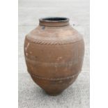 A large terracotta olive jar, 63cms (24.75ins) high.