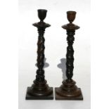 A pair of treen turned and carved candlesticks, 26cms (10.25ins) high (2).