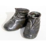 A pair of early 20th century German cast bronzed baby boots dated 1909, 13cms (5ins) long.