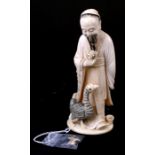 A late 19th / early 20th century Japanese ivory okimono in the form of a robed sage holding a flower