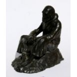 An Irish bronze sculpture depicting a weary Friar, seated on a bank, signed, Dailey, provenance: