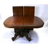 A large 19th century French oak extending dining table with two extra leaves, on turned and carved