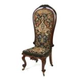 A 19th century rosewood nursing chair with tapestry upholstered seat and back.