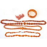 A quantity of amber beads; together with an amber bracelet.