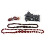 A quantity of cherry amber Bakelite beads.