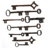 A quantity of 18th / 19th and later iron door keys, the largest 21cms (8.25ins) long.