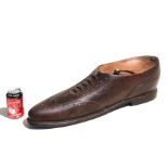 A large cobblers carved wooden oversized shop display brogue shoe with brass loop handle, 66cms (