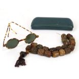 A set of carved soapstone worry beads; together with a pair of vintage faux tortoiseshell sunglasses
