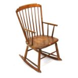 A small pine rocking chair with spindle back.