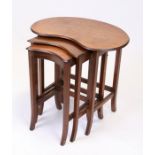 A mahogany nest of three kidney shaped occasional tables, the largest 53cms (21ins) wide.