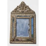 A 19th century Dutch pressed brass cushion mirror, 32 by 54cms (12.5 by 21.25ins).