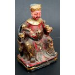 A Chinese gilded wooden figure depicting an Emperor seated on a throne, holding a rui sceptre, 28cms