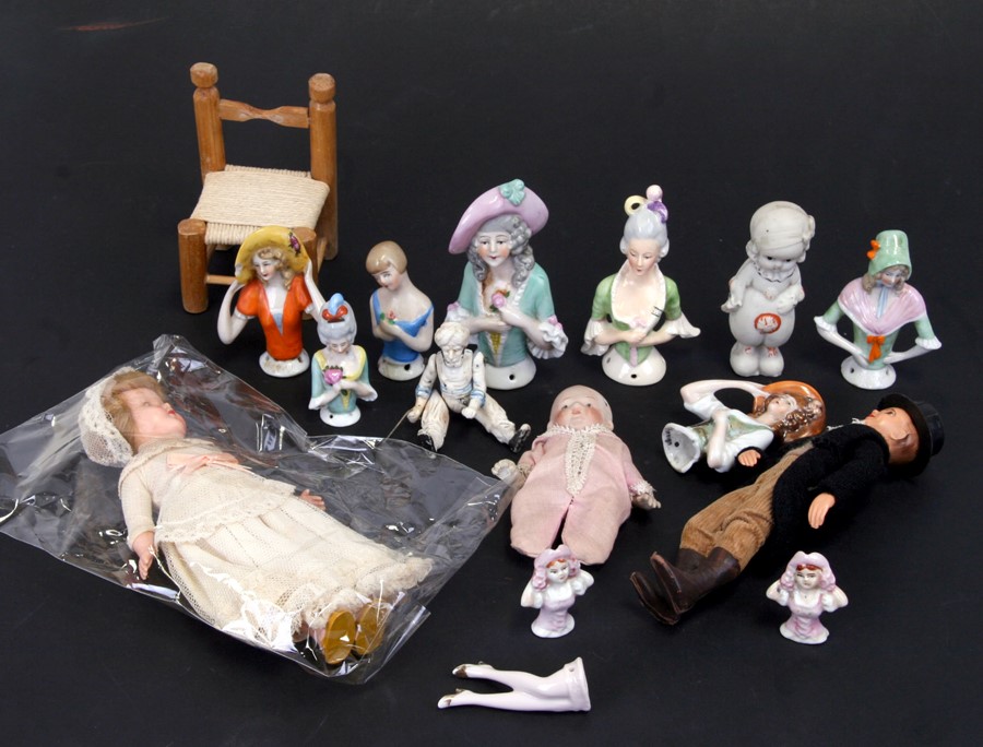 A group of porcelain pin cushion dolls, the largest 10cms (4ins) high; together with other items.