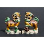 A pair of Chinese glazed pottery temple lions, 10cms (4ins) high.