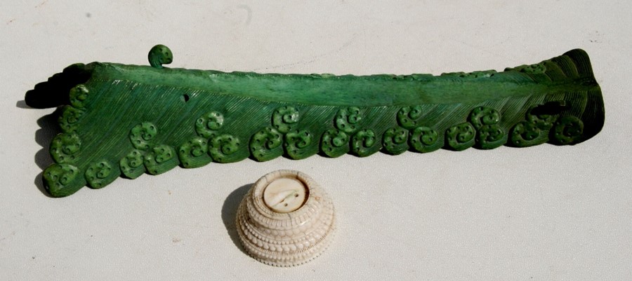 A 19th century Chinese green stained bone tusk display stand in the form of breaking waves, 31cms (