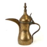 A Turkish / Islamic brass dallah coffee pot, 26cms (10.25ins) high.