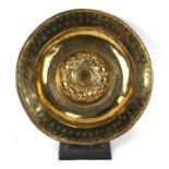 A large 17th century Nuremberg brass alms dish, 46cms (18ins) diameter.