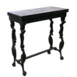 A 19th century Anglo Indian or Sri Lankan coromandel or ebony fold-over card table on figural