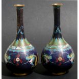 A pair of Chinese cloisonne bottle vases decorated with dragons chasing a flaming pearl on a blue