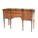 A George III style mahogany serpentine fronted sideboard with two central drawers flanked by