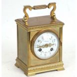 A Victorian brass cased carriage clock, the white enamel dial with Arabic numerals, with French