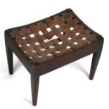 An Arts & Crafts oak stool by Arthur Simpson of Kendall, with lattice work leather seat, 40cms (15.