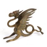 A brass figure in the form of a griffin or wyvern, 14cms (5.5ins) high.
