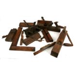 A collection of woodworker's tools including planes, moulding planes and other similar items.