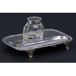 A silver desk stand with central glass inkwell and silver lid, Birmingham 1910, 16cms (6.25ins)