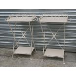 A pair of painted metal folding bedside tables. 57cm (22.5 ins) wide