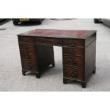 A reproduction mahogany pedestal desk with an arrangement of nine drawers, 122cms (48ins) wide.