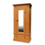 A pine single wardrobe with full length door mirror, 87cms (34ins) wide.