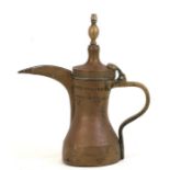 A large Turkish / Islamic brass dallah coffee pot with impressed mark. 33cm (13 ins) high