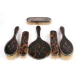 A George V silver & tortoiseshell five-piece dressing table set, Birmingham 1922; together with a