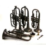 A Boosey & Hawkes b.flat cornet; together with three similar cornets and a mute (5).