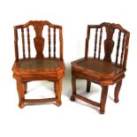 A pair of Chinese chairs with vase shaped splats and solid seats (2).
