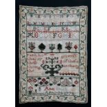 An 18th century needlework sampler decorated with alphabets and foliate arrangements with