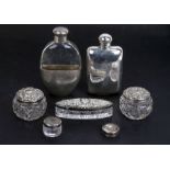A Victorian silver hip flask, London 1899, a group of silver topped dressing table jars and a silver