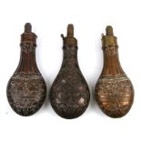 Three 19th century embossed copper & brass powder horns.