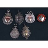 Five silver fob medallions and a guilloche and enamel silver lapel badge, various makers and