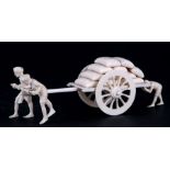 A late 19th / early 20th century Indian ivory cart loaded with sacks being pulled by two figures,