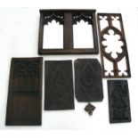 A Gothic oak framed wall mirror; together with various oak carvings and panels and clock parts.