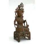 A Chinese gilded metal Buddha figure kneeling on a pierced stool and holding a sceptre, 30cms (