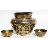 A Persian brass planter decorated with animals and figures, 23cms (9ins) high; together with two
