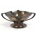 An Arts & Crafts silver plated pedestal bowl with planished decoration, four loop handles and rope