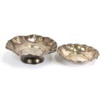 A white metal bowl on stand; together with a similar silver plated bowl, the largest 25cms (9.75ins)