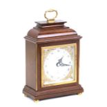 An Elliott mahogany cased mantle clock with silvered dial and Roman numerals, retailed by Mallory of