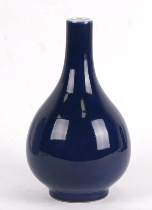A Chinese blue glazed bottle vase with six character blue mark to the underside, 24cms (9.5ins)