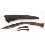 A kukri in a leather scabbard, 44cm (17.25ins) long.